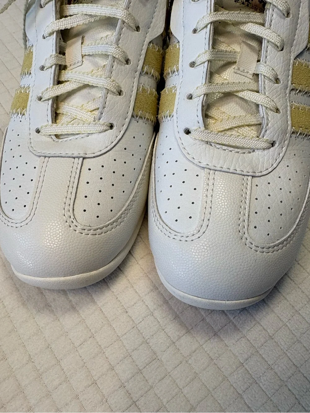 Adidas cream colored sneakers with floral accents